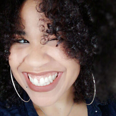 About woman with curly hair smiling